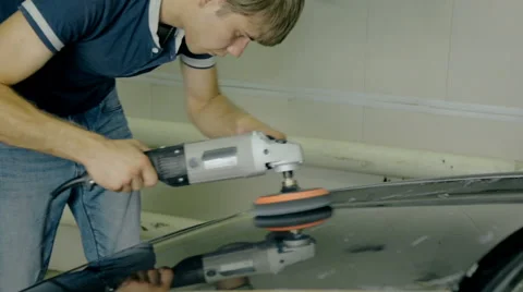 Mid shot Worker polish black car with special tools Stock Footage 65760256
