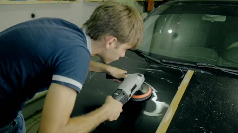Mid shot Worker polish black car with special tools Stock Footage 65760367