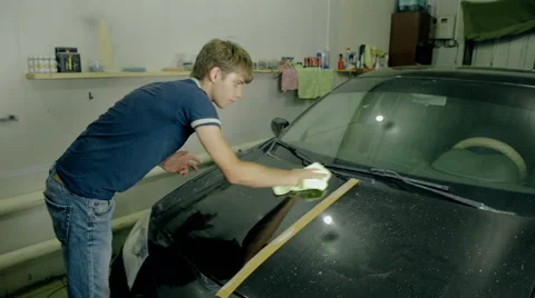 Mid shot Worker polish black car with special tools Stock Footage 65760522