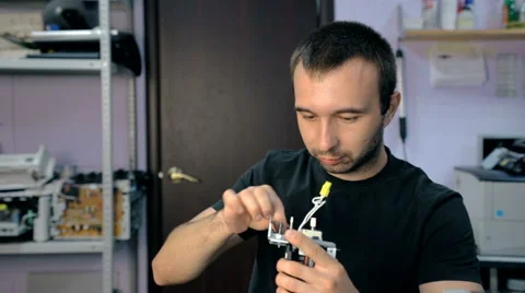 Mid shot Worker repairs electronic stuff Stock Footage 65512343