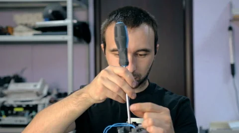 Mid shot Worker repairs electronic stuff Stock Footage 65512382