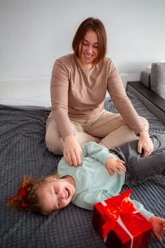 Mid shot of young mother and her daughter are playing and having fun together Stock Photos