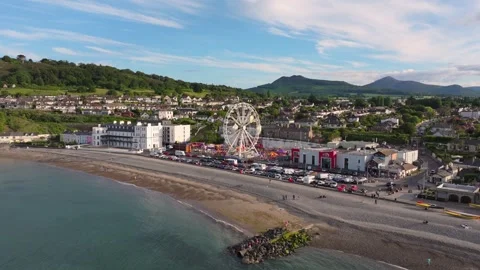 Midday View of Irish Seafront Amusement Park, Pebble Beach and Town Stock Footage 338067623