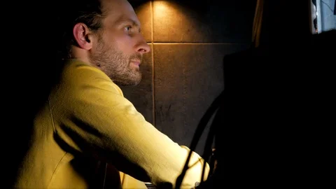 Middle age bearded focused on code of developing software at dark room Video stock 105336551