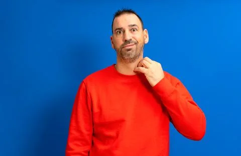 Middle age bearded man scratching himself highlighted with red collar on as.. Stock Photos