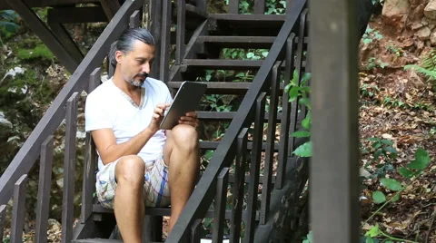 Middle age brunette man using digital tablet Stock Footage 41321260