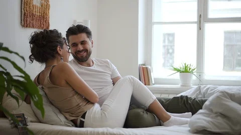 Middle age couple lying in bed laughing Spbd. Happy married couple lying in bed Video stock 127741747