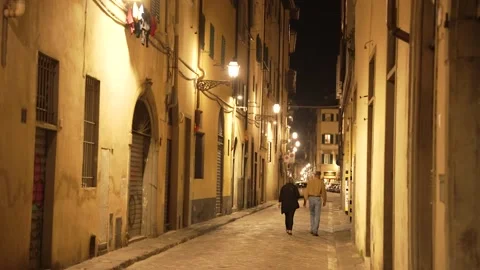Middle age couple walking down an old historic Italian street Stock Footage 221072365