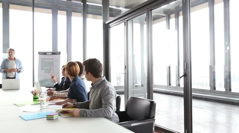 Middle age creative director discussing on a meeting with colleagues Stock Footage 59544056