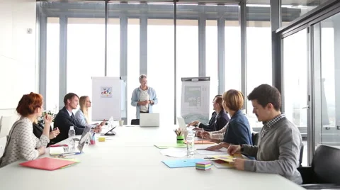 Middle age creative director discussing on a meeting with colleagues Stock Footage 59544058