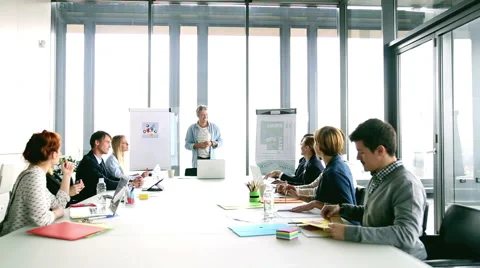 Middle age creative director discussing on a meeting with colleagues Stock Footage 59544060