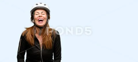 Middle age cyclist woman using earphones stressful, terrified in panic, shout Stock Photos