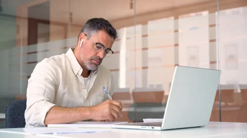 Middle-age Hispanic man using computer remote for business studying, online work Stock Footage 242172719