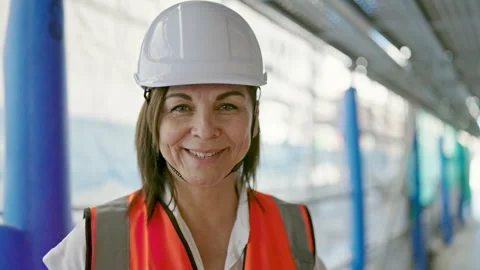Middle age hispanic woman builder smiling confident standing at constructio.. 스톡 동영상 245054252