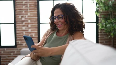 Middle age hispanic woman using smartphone Stock Footage 162878433