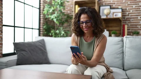 Middle age hispanic woman using smartphone Stock Footage 162878440