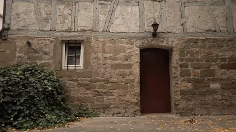 Middle age house facade with red door and window Video stock 100274980