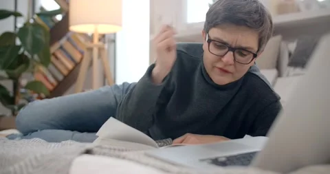 Middle age lady makes notes at the online remote education course, distance Stock Footage 236995272