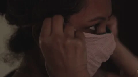 Middle age lady putting handmade mask before going out for work Stock Footage 185104350