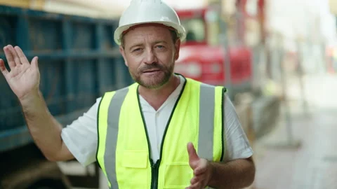 Middle age man architect smiling confident speaking at street Stock Footage 230918359