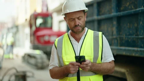 Middle age man architect using smartphone at street Stock Footage 223726081