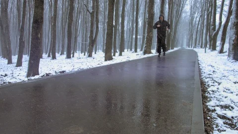 Middle age man doing physical exercices outdoor on a snowy day. Motivational Stock Footage 103435907