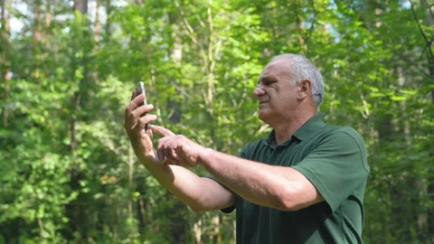 Middle age man Got Lost In A Forest Trying To Find Mobile Phone Connection. Stock Footage 157072901