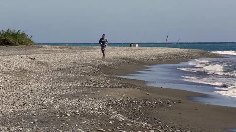 Middle age man jogging on beach on caribbean coast during corona virus. Stock Footage 141822193