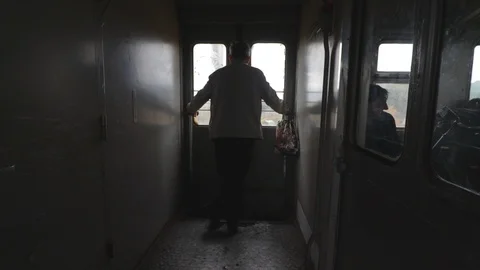 Middle age man looking through the window of moving suburban train in autumn Vidéo 118044806