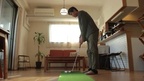 Middle age man practicing golf putting at home. Stock Footage 224905152