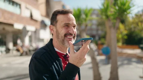 Middle age man smiling confident talking on the smartphone at street Video stock 171067346