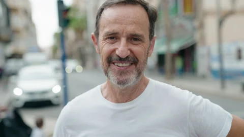 Middle age man smiling confident speaking at street Stock Footage 205527290