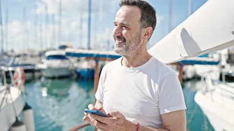 Middle age man smiling confident using smartphone at boat Stock-Footage 243514066