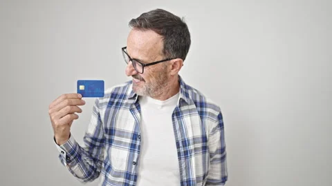Middle age man smiling confident pointing to credit card over isolated whit.. Stock Footage 243515255