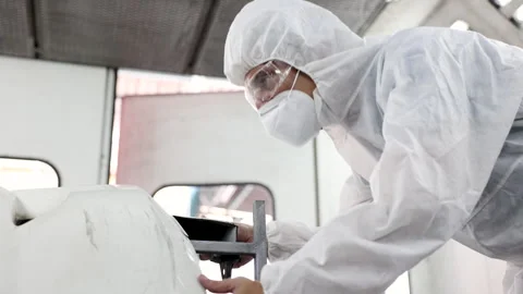 Middle age man using auto polisher to wax body parts, garage business owner.. Stock Footage 246066065