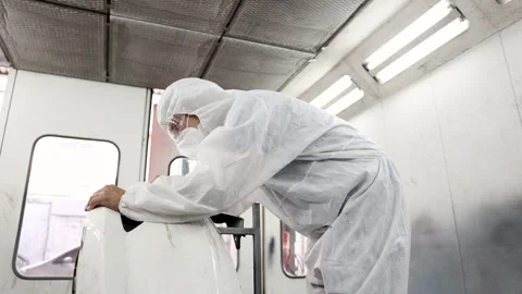 Middle age man using auto polisher to wax body parts, garage business owner.. Stock Footage 246067104