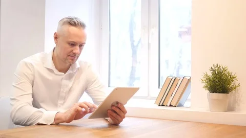 Middle Age Man Using Tablet at Work Video stock 70941058