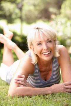 Middle age woman posing in park Stock Photos