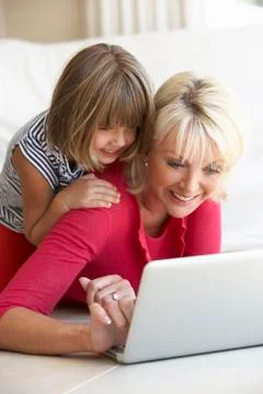 Middle age woman with young girl using laptop computer Stock Photos