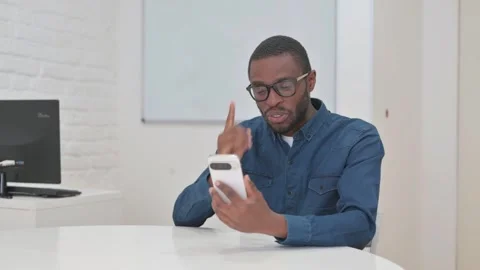 Middle Aged African Man Doing Video Chat with Phone Stock Footage 309513179