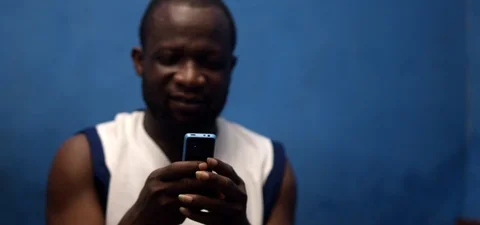 Middle aged African Man looking at his mobile phone Stock Footage 112142220