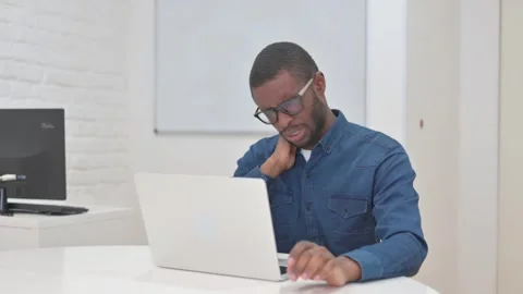 Middle Aged African Man with Neck Pain at Work Stock Footage 309511933
