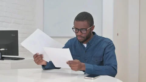 Middle Aged African Man Reading Annual Business Report of Company Video stock 309512862