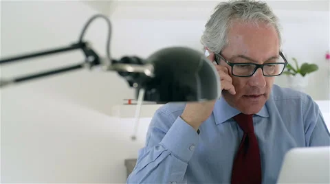 Middle aged and good looking business man, talk at mobile phone. Video stock 62650255