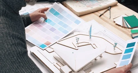 Middle aged Architect with gray Beard and Eyeglasses choosing right Color for Stock Footage 126252916