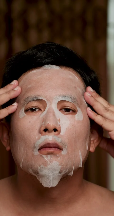 Middle-aged Asian man applied sheet face mask. Stock Footage 278739826
