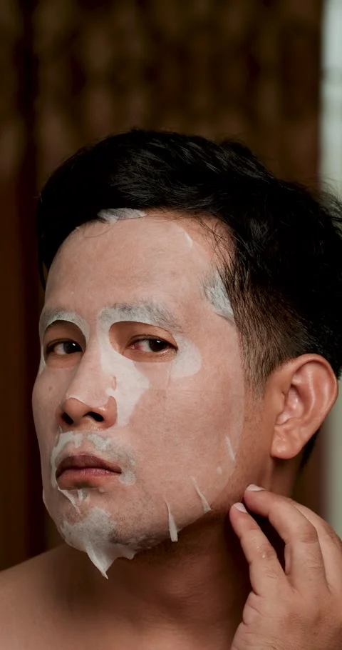 Middle-aged Asian man applied sheet face mask. Stock Footage 278739827