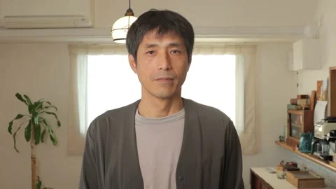 Middle aged asian man opens his eyes and stares the camera. Emotionless. 25P. Stock Footage 224899854