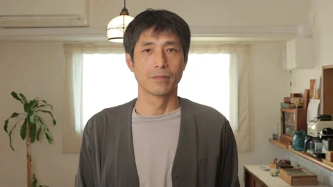 Middle aged asian man opens his eyes and stares the camera. Emotionless. Stock Footage 224904218