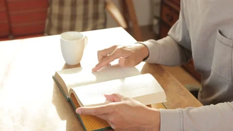 Middle aged asian man reading a book at home. 25P. Stock Footage 224900913
